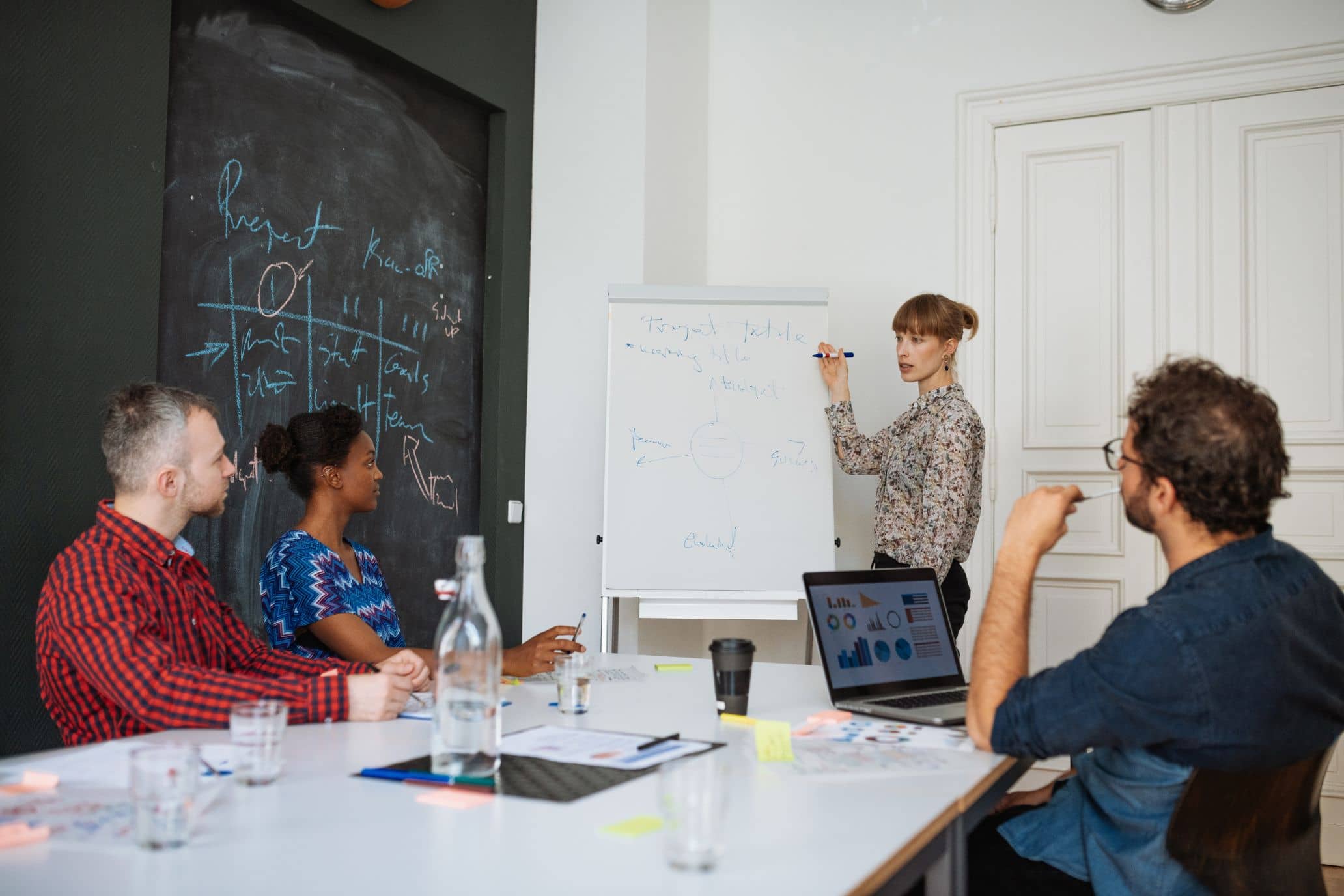 A group of people are gathered around a table, engaged in a discussion about non-profit planning.